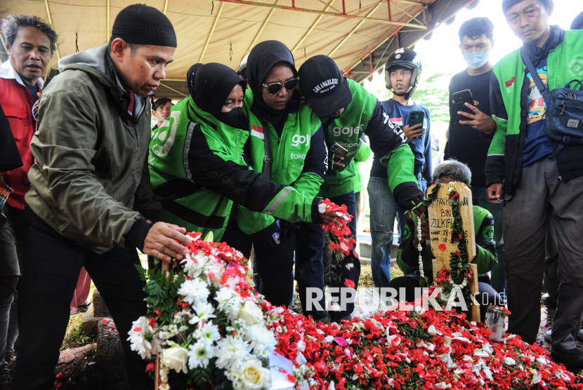 Para kerabat menaburkan bunga di makam Affan Kurniawan (21) di TPU Karet Bivak, Jakarta, Jumat (29/8/2025).