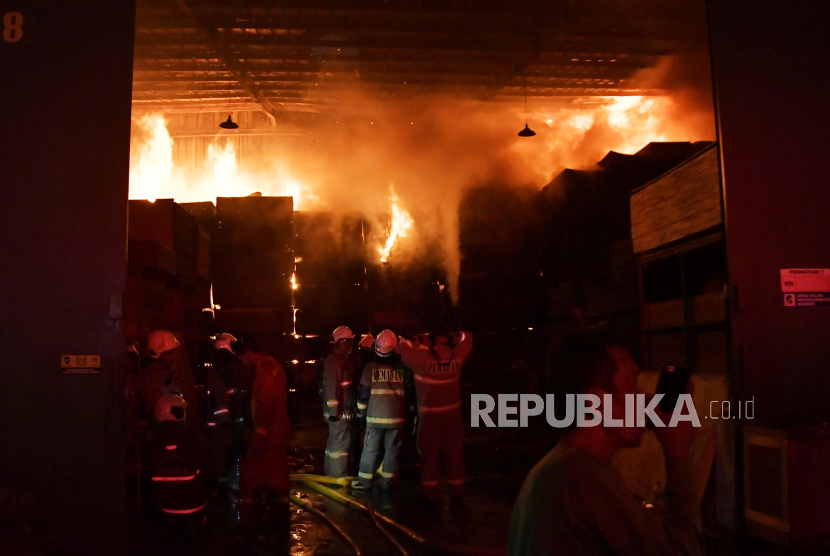 Sejumlah petugas pemadam kebakaran memadamkan api pada kebakaran gudang triplek di Pondok Bambu, Jakarta Timur, Selasa (30/5/2023) malam. 