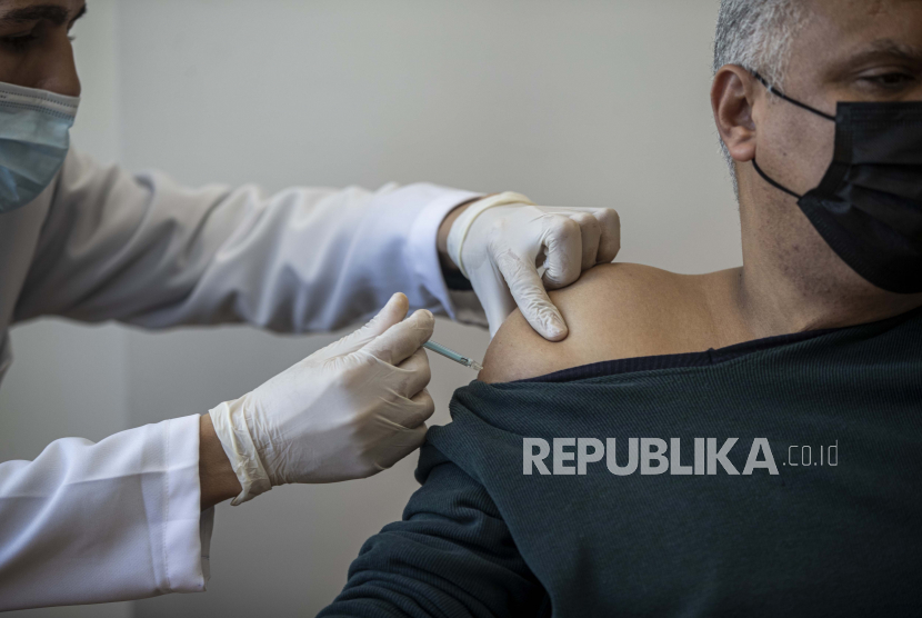 Seorang pria menerima suntikan vaksin virus corona Sputnik V buatan Rusia. ilustrasi
