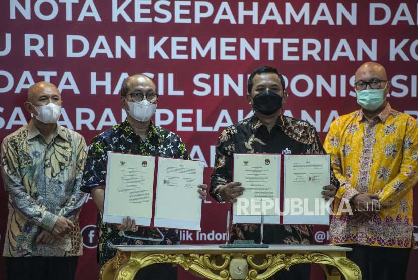 Ketua KPU Ilham Saputra (kanan) dan Menteri Koperasi dan UKM Teten Masduki (kiri) menyaksikan penandatanganan kerja sama tentang data pada Pemilu, Pemilihan Gubernur, Bupati dan Walikota untuk pendataan sasaran pelaksanaan BPUM yang ditandatangani oleh Sekjen KPU Bernad Dermawan Sutrisno (kedua kanan) dan Sekretaris Kementerian Koperasi dan UKM Arif Rahman Hakim (kedua kiri) di Kantor KPU, Jakarta, Kamis (29/4/2021). Ruang lingkup kerja sama tersebut meliputi penyusunan standar operasional prosedur (SOP) pemanfaatan, pengelolaan dan penggunaan data pemilih berusia paling rendah 18 tahun sebagai salah satu dasar verifikasi pendataan sasaran pelaksaan Bantuan Pemerintah bagi Pelaku Usaha Mikro (BPUM) dalam rangka meningkatkan jumlah penerima BPUM. 