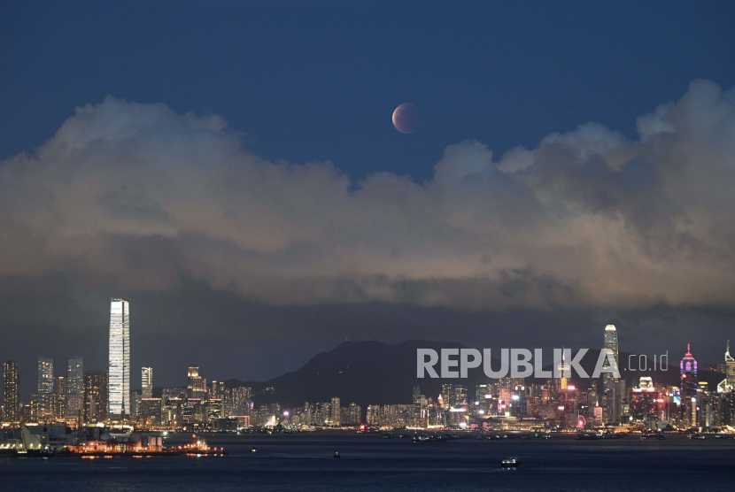 Bulan terbit di atas Pelabuhan Victoria di Hong Kong, Rabu, 26 Mei 2021.