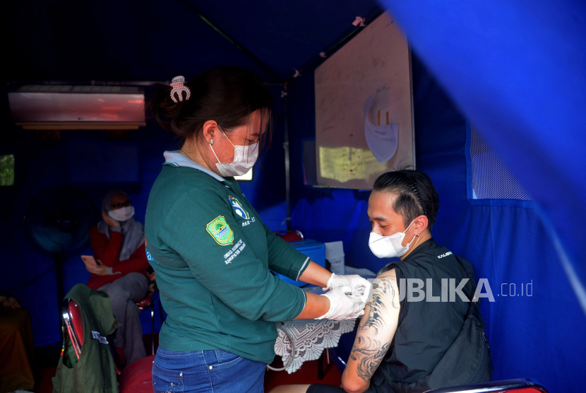 Petugas kesehatan menyuntikan vaksin covid-19 kepada seorang pemudik di Rest Area 86 ruas Tol Cipali, Jawa Barat, Selasa (26/4/2022). Layanan vaksinasi tersebut ditujukan untuk mempermudah pemudik yang belum sempat mendapat vaksin, baik dosis pertama, kedua maupun ketiga atau booster sebagai upaya mendukung pemerintah dalam mempercepat penanggulangan pandemi Covid-19. Orang yang telah mendapatkan vaksin masih bisa kena Covid-19. 