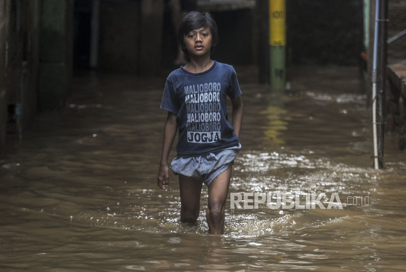 Anak-anak berjalan melewati banjir (ilustrasi)