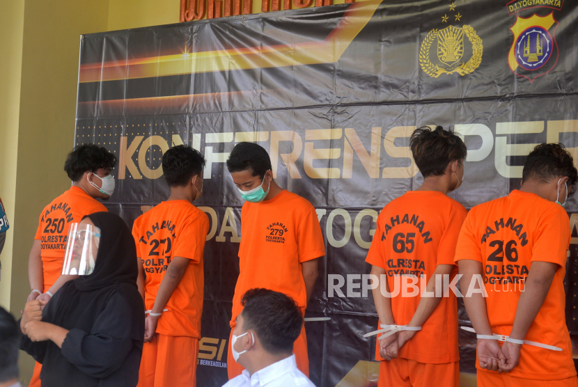 Tersangka pelaku kejahatan jalanan atau klitih dihadirkan saat konferensi pers di Mapolda DIY, Yogyakarta, Senin (11/4/2022). Sebanyak lima tersangka berstatus pelajar dan mahasiswa diamankan dari kasus penganiyaan pelajar SMA hingga meninggal. Pelaku dijerat dengan Pasal 353 Ayat (3) Juncto Pasal 55 atau Pasal 351 Ayat (3) Juncto Pasal 55 KUHP dengan ancaman hukuman 7 tahun penjara. Barang bukti celurit, pedang, serta hear sepeda motor turut dihadirkan dalam konferensi pers ini.