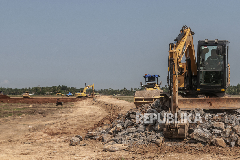 Pekerja menggunakan alat berat menyelesaikan proyek pembangunan jalan tol (ilustrasi) 