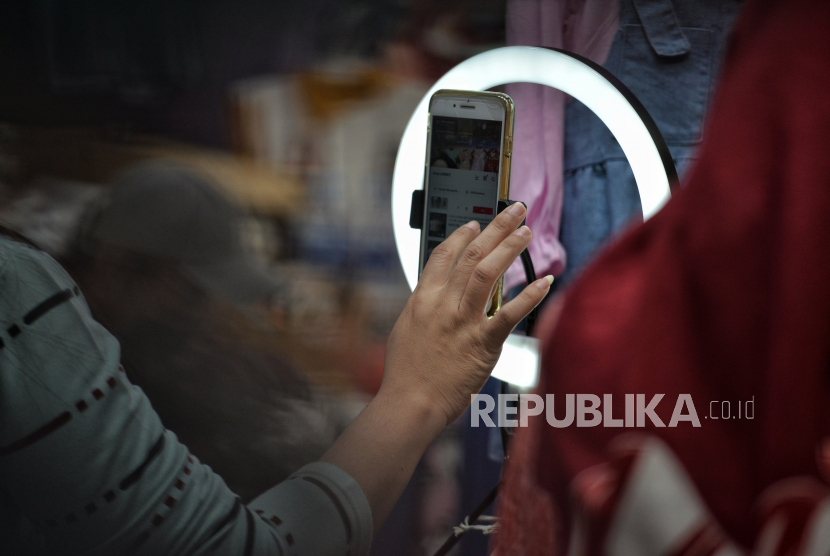 Pedagang menjual pakaian anak melalui siaran streaming di Pasar Tanah Abang Blok B, Jakarta. Menurut pemilik toko, penjualan online menjadi alternatif  di tengah menurunnya penjualan secara langsung. Selain itu, sekitar 80 persen dari total omset penjualan dihasilkan melalui penjualan secara online. Republika/Thoudy Badai