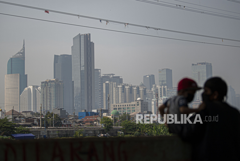 Warga bermain bersama anaknya dengan latar belakang gedung-gedung di Petamburan, Jakarta, Selasa (28/7). Kementerian Keuangan (Kemenkeu) mencatat, realisasi anggaran Pemulihan Ekonomi Nasional (PEN) per Rabu (26/8) mencapai Rp 192,53 triliun.