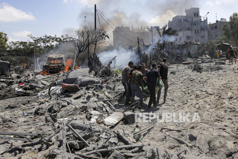 Warga Palestina mengevakuasi seorang korban jiwa dari lokasi pemboman di Khan Younis, Jalur Gaza selatan, Sabtu (13/7/2024). 