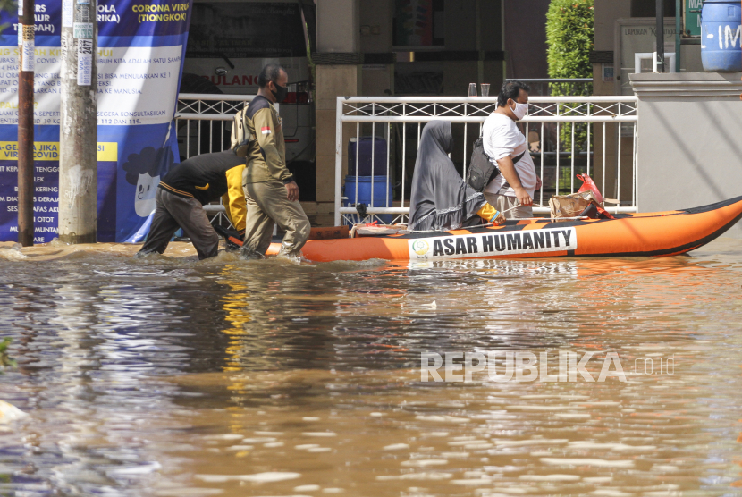 Warga melintas menggunakan perahu karet ditengah banjir di Bukit Sawangan Indah, Depok, Jawa Barat. Banjir setinggi 60 cm - 100 cm tersebut disebabkan karena meluapnya aliran air kali Angke dan tanggul yang tidak mampu menahan debit air. (Ilustrasi)