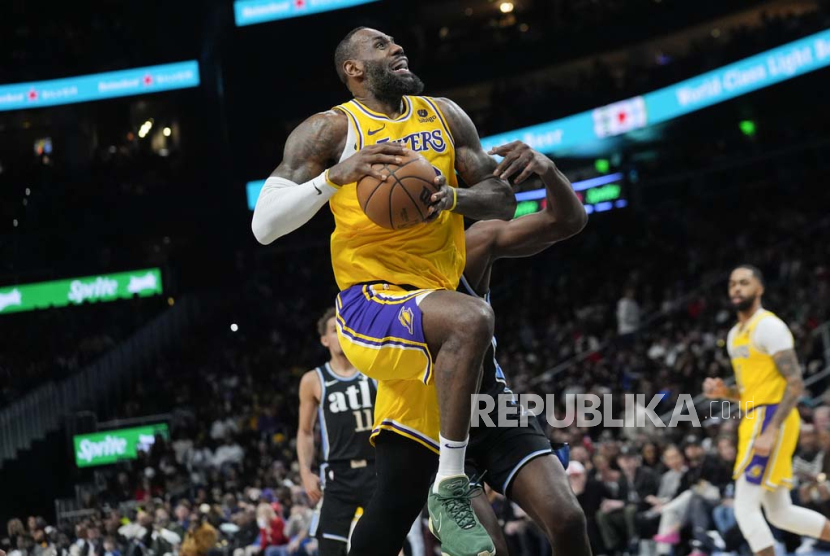 Los Angeles Lakers forward LeBron James (23) goes past Atlanta Hawks center Clint Capela (15) as he scores a basket in the second half of an NBA basketball game Tuesday, Jan. 30, 2024, in Atlanta. 
