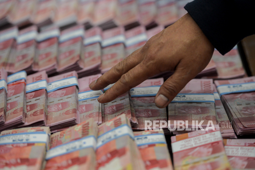 Petugas merapikan barang bukti uang palsu saat konferensi pers di Gedung Bareskrim Mabes Polri, Jakarta, Kamis (23/9). (Ilustrasi)