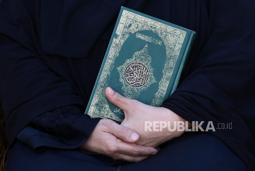  Seorang wanita memegang kitab suci Alquran (ilustrasi). Dewan Hak Asasi Manusia Perserikatan Bangsa-Bangsa (HAM PBB)  menyetujui resolusi tentang kebencian agama. 