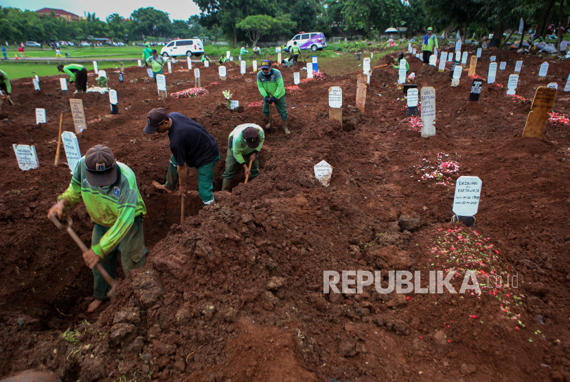 Petugas menggali liang lahat untuk jenzah COVID-19 di TPU Bambu Apus, Jakarta, Ahad (24/1/2021). Pemprov DKI Jakarta membuka lahan pemakaman untuk jenazah COVID-19 di TPU Bambu Apus dengan kapasitas 700 liang lahat. 