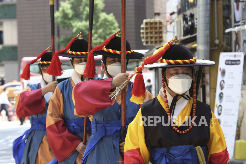 Penjaga Kekaisaran Korea Selatan mengenakan masker wajah untuk membantu melindungi terhadap penyebaran virus corona 