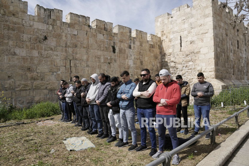 Palestinian Muslims pray outside of the walls of the Old City of Jerusalem after Israeli police denied their entry to the Al-Aqsa Mosque compound for Friday prayers, Friday, March 1, 2024.
