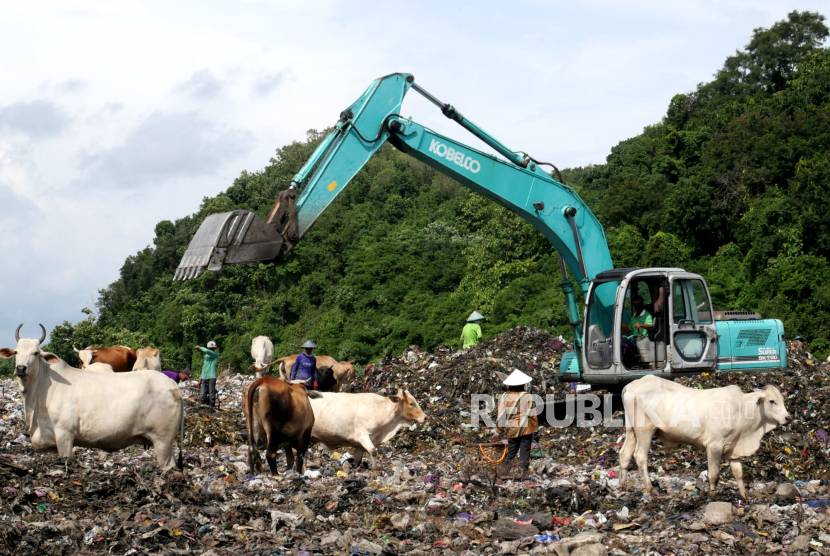 Eksavator mengurai gundukan sampah  di TPST Piyungan, Bantul, Yogyakarta, Selasa (22/12). Sejak Jumat (18/12) jalan akses menuju pembuangan sampah TPST Piyungan diblokir oleh warga sekitar.