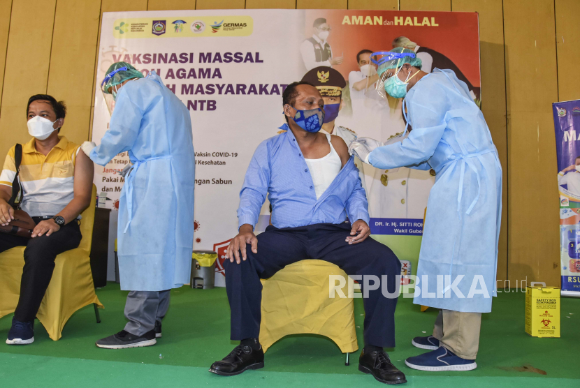 Petugas kesehatan menyuntikkan vaksin COVID-19 tahap pertama kepada tokoh masyarakat di Islamic Center NTB di Mataram, NTB, Senin (29/3/2021). Pemerintah Provinsi NTB melaksanakan vaksinasi massal untuk tokoh agama dan tokoh masyarakat NTB yang diikuti oleh sebanyak 700 orang peserta per hari dalam rangka percepatan vaksinasi COVID-19 di Provinsi NTB.