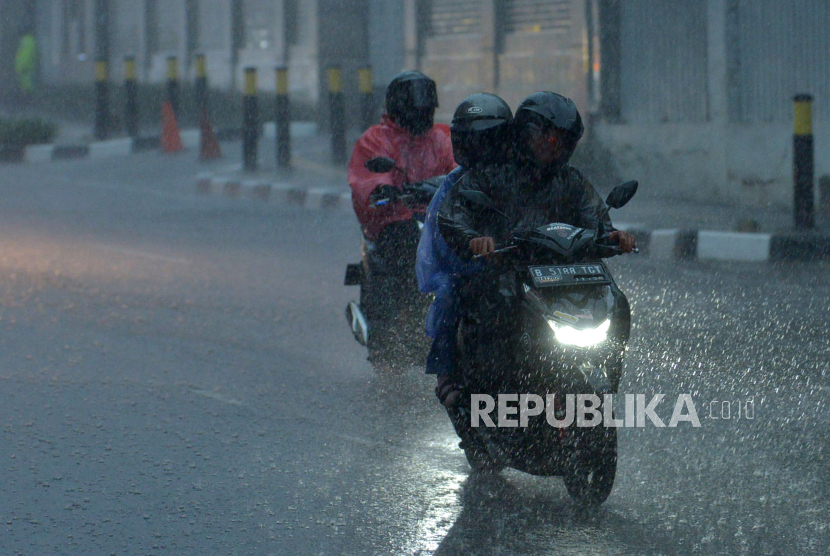 Pengendara motor mengenakan jas hujan saat berkendaraan melintasi guyuran hujan di Jakarta, Selasa (4/10/2022). Badan Meteorologi, Klimatologi, dan Geofisika (BMKG) menyebut pada awal Oktober 2022 sebanyak 40,3% zona musim (ZOM) di Indonesia sudah memasuki musim hujan. Cuaca Hari Ini: Beberapa Wilayah DKI Jakarta Berpotensi Hujan