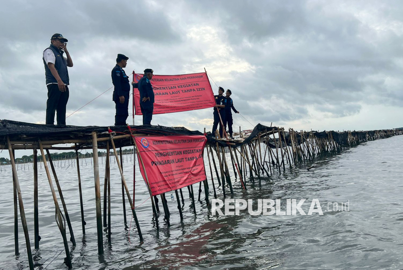 Sejumlah petugas Direktorat Jenderal Pengawasan Sumber Daya Kelautan dan Perikanan (PSDKP) Kementerian Kelautan dan Perikanan (KKP) menyegel lokasi pemagaran laut sepanjang 30,16 km di perairan pesisir Tangerang, Banten, Kamis (9/1/2025). KKP menyegel pagar tersebut karena pemagaran tersebut diduga tidak memiliki izin dasar Kesesuaian Kegiatan Pemanfaatan Ruang Laut (KKPRL). 