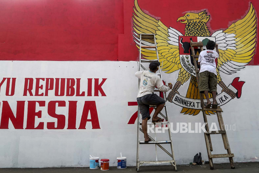 Pekerja melukis mural dengan lambang negara (Garuda Pancasila) di dinding sebagai bagian dari persiapan perayaan Hari Kemerdekaan negara, di Tanggerang, Banten, Indonesia, 09 Agustus 2022. Indonesia sedang bersiap untuk merayakan ulang tahun ke-77 kemerdekaannya pada 17 Agustus.