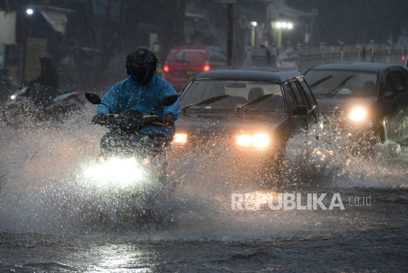 Pengendara melintasi genangan air yang menutupi ruas jalan di kawasan Mampang Prapatan, Jakarta, Ahad (19/9).  Genangan setinggi 20 sampai 30 centimeter tersebut terjadi sekitar pukul 17.30 WIB akibat curah hujan yang tinggi dan sistem drainase yang buruk. Republika/Thoudy Badai
