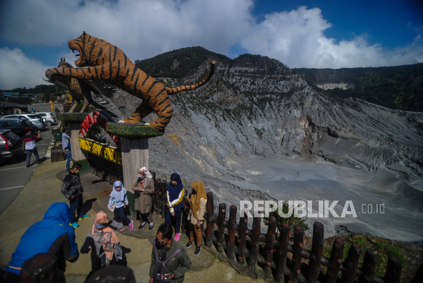 Pengunjung menikmati pemandangan kawah ratu di Taman Wisata Alam Gunung Tangkuban Parahu di Kabupaten Subang, Jawa Barat.