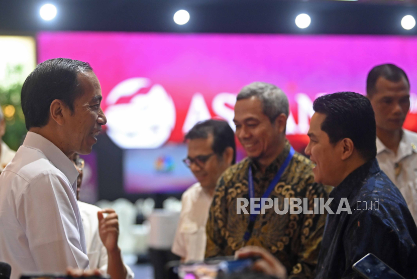 Presiden Joko Widodo (kiri) berbincang dengan Menteri BUMN Erick Thohir (kanan).