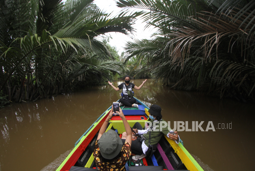 Wisatawan menikmati suasana alam saat wisata susur sungai di Hutan Mangrove Alami (ilustrasi)