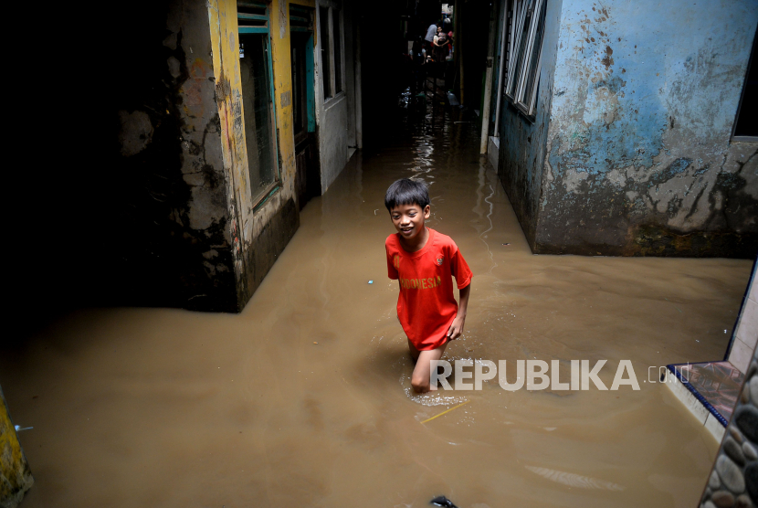 Seorang anak melintasi banjir yang merendam kawasan Kebon Pala, Kampung Melayu, Jakarta, Sabtu (16/7/2022). Banjir setinggi 40-170 centimeter tersebut terjadi akibat meluapnya air sungai Ciliwung yang dipicu oleh tingginya curah hujan yang mengguyur wilayah Jakarta, Bogor, dan Depok sejak Jumat (15/7/2022) malam hingga Sabtu pagi.Prayogi/Republika.