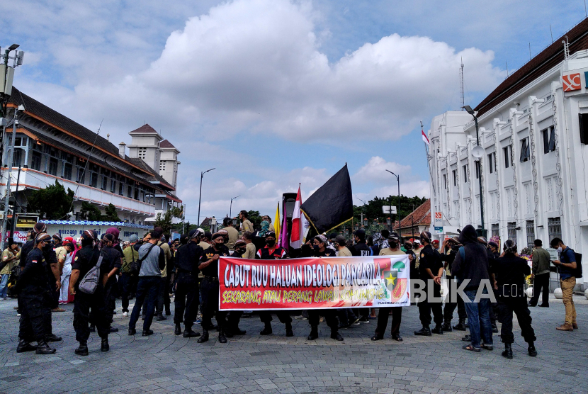 Peserta aksi dari Aliansi Jogja Bersatu menggelar unjuk rasa di Titik Nol Yogyakarta, Senin (6/7). Dalam aksinya mereka menuntut pencabutan RUU Haluan Idiologi Pancasila (HIP) di DPR RI.