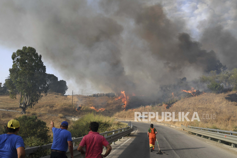 Relawan mencoba mengendalikan api di Kotamadya Blufi, di Madonie atas, dekat Palermo, Sisilia, Italia, karena banyak kebakaran hutan terus melanda wilayah tersebut. 