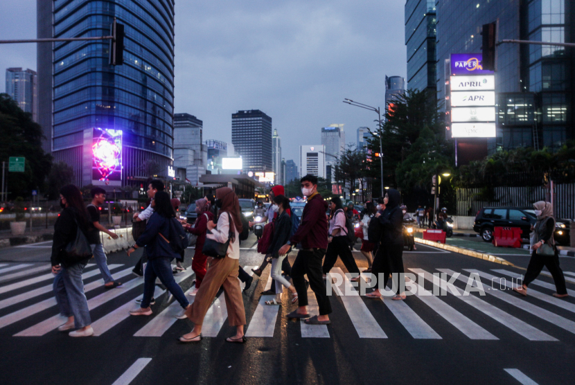 Pekerja melintasi pelican crossing di kawasan Sudirman, Jakarta. Menurut data BPS, jumlah kelas menengah RI dalam tren penurunan beberapa tahun terakhir.