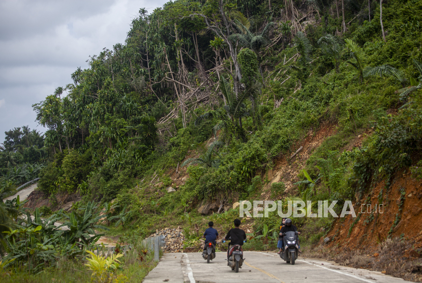 Sejumlah pengendara melintasi jalan perbukitan yang rawan longsor di Kecamatan Serasan, Kabupaten Natuna, Kepulauan Riau, Ahad  (12/3/2023). 