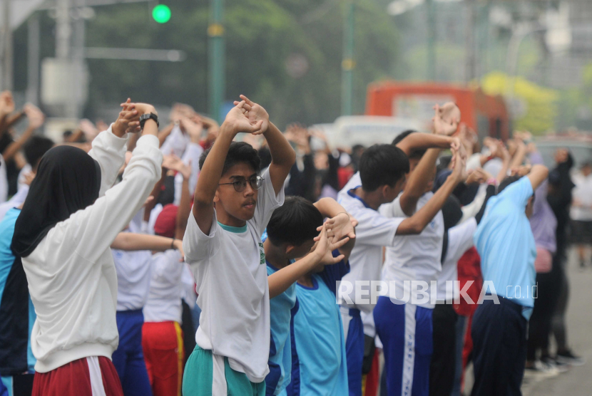 Pelajar melaksanakan senam saat Hari Bebas Kendaraan Bermotor (HBKB) di kawasan Bundaran HI, Jakarta, Ahad (7/5/2023). 