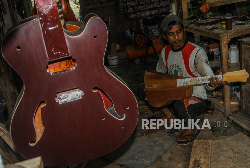 Pekerja memproduksi gitar di Workshop Guitars Gore di Lebak, Banten, Selasa (17/2/2020). OJK memberikan kelonggaran pembayaran pokok pinjaman serta bunga bagi pengusaha sektor usaha mikro kecil dan menengah (UMKM) kepada perbankan guna menyikapi dampak negatif virus corona (COVID-19) pada industri. ANTARA FOTO/Muhammad Bagus Khoirunas/aww.
