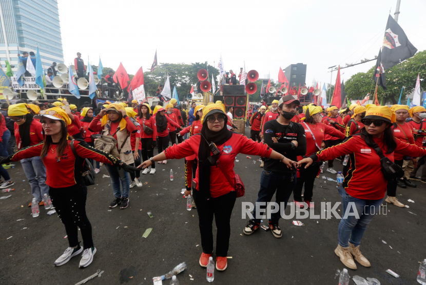 Pengunjuk rasa bergandengan tangan saat memprotes UU Omnibus Law di Jakarta, Indonesia, 10 Agustus 2022. Lebih dari seribu buruh Indonesia menggelar unjuk rasa mendesak DPR agar membatalkan Omnibus Law penciptaan lapangan kerja.