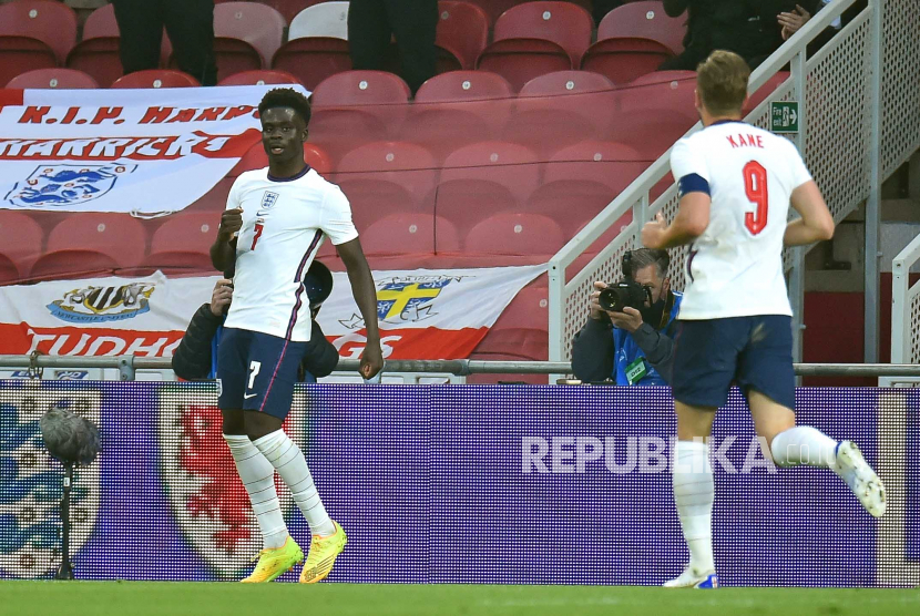 Pemain Inggris Bukayo Saka (kiri) merayakan dengan rekan setimnya, Harry Kane (kanan), setelah mencetak keunggulan 1-0 selama pertandingan sepak bola Persahabatan Internasional antara Inggris dan Austria di Middlesbrough, Inggris, 02 Juni 2021.