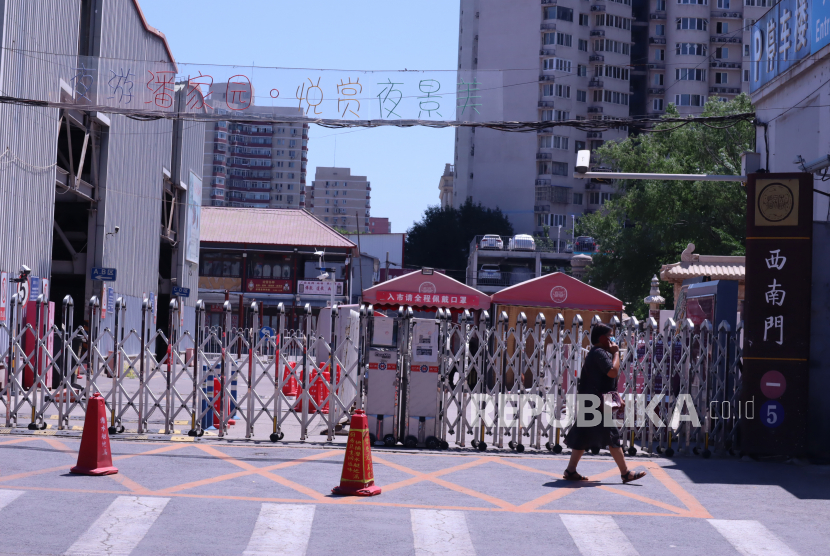 Seorang pejalan kaki melintas di depan Pasar Panjiayuan yang masih tutup di Beijing, China, Kamis (26/5/2022). China telah menerapkan karantina wilayah (lockdown) di provinsi Anhui tengah.