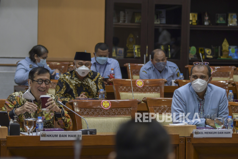 Menteri Hukum dan HAM Yasonna Laoly (kiri) bersama Wakil Menteri Hukum dan HAM Edward Omar Sharif Hiariej (kanan)  bersiap mengikuti rapat kerja dengan Komisi III DPR di Kompleks Parlemen, Senayan, Jakarta, Senin (6/12/2021). Rapat tersebut membahas pengambilan keputusan tingkat I RUU tentang Kejaksaan. 