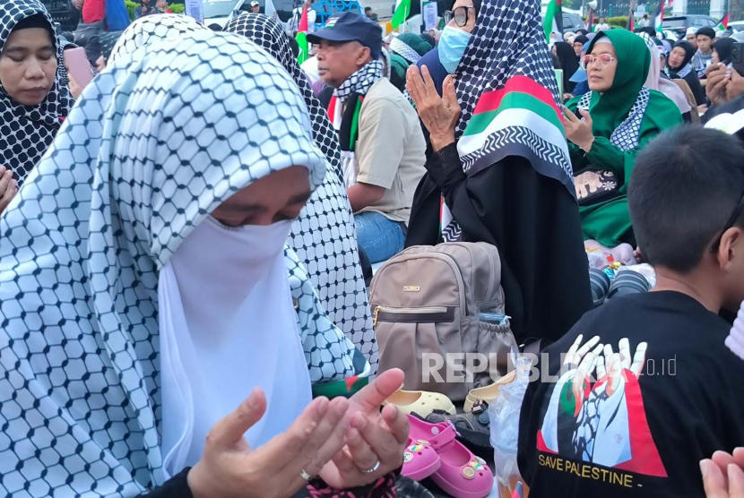 Ribuan masyarakat Indonesia berdoa menjelang buka puasa Ramadhan di acara Doa Untuk Gaza di depan pintu Monas di sebrang Patung Arjuna Wijaya atau yang biasa dikenal masyarakat sebagai 