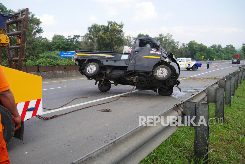 Petugas Jasa Marga mengevakuasi mobi pickup yang terguling di Tol Cipularang. Kendaraan menuju Bandung tak bisa melintas karena truk terguling di Tol Cipularang.