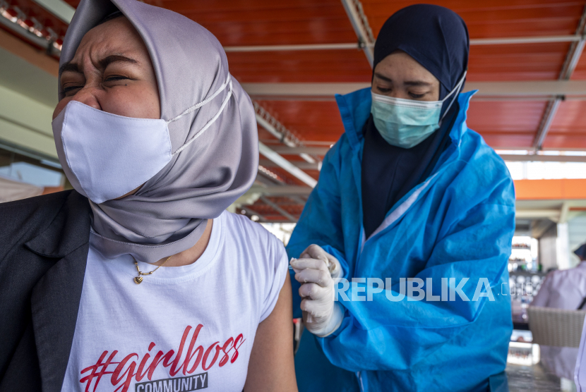 Seorang pekerja pariwisata disuntik vaksin COVID-19 di Palu, Sulawesi Tengah, Rabu (24/3/2021). Sebanyak 710 orang pekerja sektor pariwisata mengikuti vaksinasi COVID-19 secara massal yang diinisiasi oleh Perhimpunan Hotel dan Restauran Indonesia (PHRI) Sulawesi Tengah.