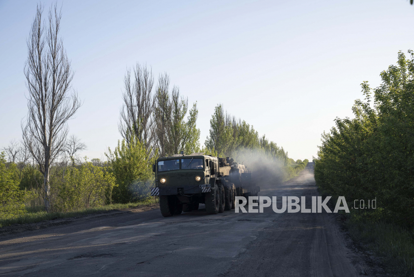 Sebuah truk militer mengangkut platform dengan kendaraan lapis baja Ukraina di wilayah Donetsk, Ukraina, Minggu, 8 Mei 2022.