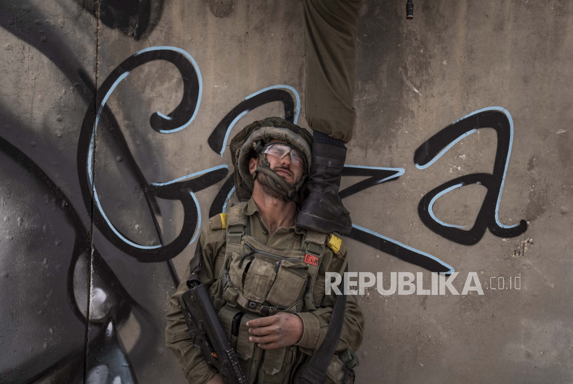 Tentara Israel memanjat tembok saat mereka menyerang sebuah kompleks selama latihan perang perkotaan di fasilitas pelatihan tentara di pangkalan militer Zeelim, Israel selatan, 24 Januari 2022. PBB terus memberi tekanan untuk penerapan solusi dua negara guna menyudahi konflik Israel-Palestina.