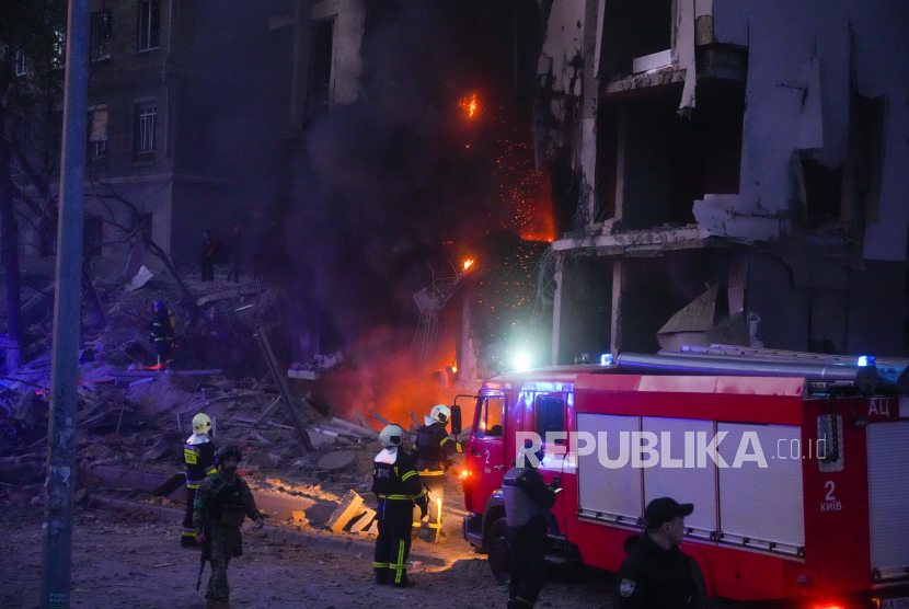 Firefighters put out a fire after a Russian rocket attack in Kyiv, Ukraine, Thursday, April 28, 2022. Russia mounted attacks across a wide area of Ukraine on Thursday, bombarding Kyiv during a visit by the head of the United Nations.