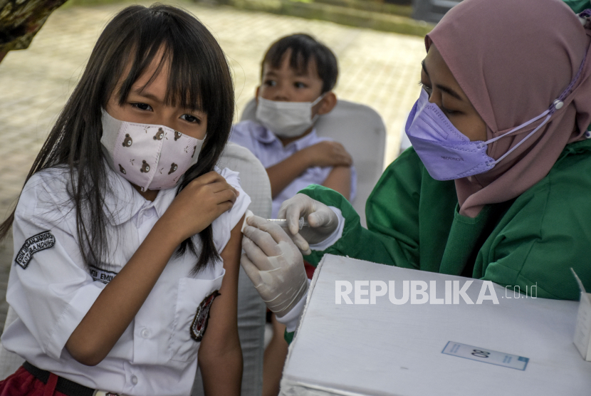 Vaksinator menyuntikkan vaksin Covid-19 ke siswa Sekolah Dasar (SD) saat pelaksanaan vaksinasi Covid-19 bagi anak usia 6-11 tahun di Taman Dewi Sartika, Jalan Wastukencana, Kota Bandung. (Ilustrasi)