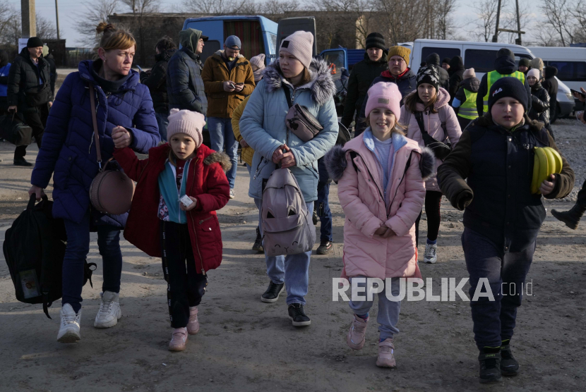 Pengungsi berangkat ke Rumania setelah melarikan diri dari Ukraina. Mereka berjalan di perbatasan di Palanca, Moldova, Kamis, 17 Maret 2022. Pusat Pencegahan dan Pengendalian Penyakit Eropa (ECDC) menilai, negara-negara yang menampung pengungsi perlu menyediakan tes dan vaksin Covid-19. 
