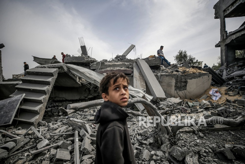 Seorang anak mencari anggota keluarganya yang hilang di Gaza.