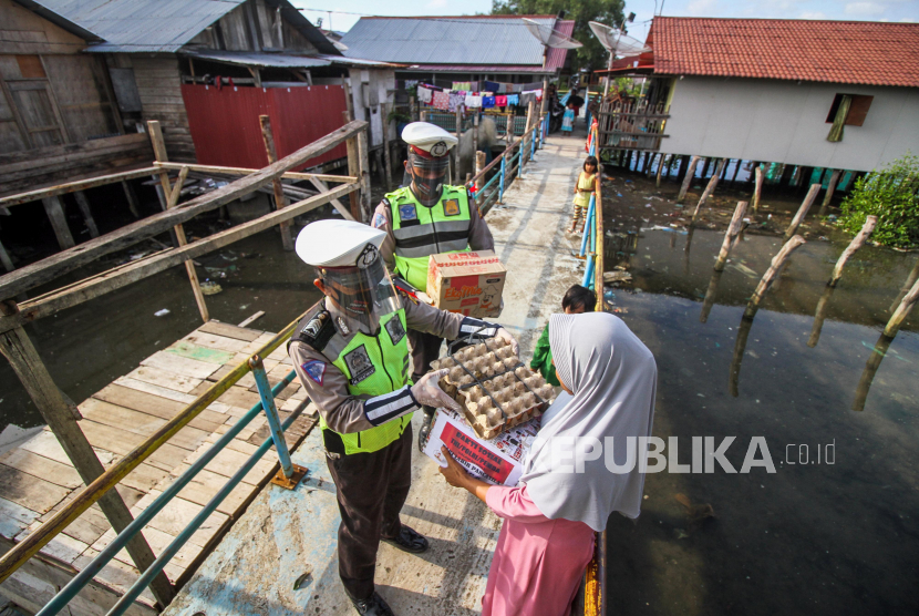 Polisi membagikan paket sembako kepada warga prasejahtera (ilustrasi) 