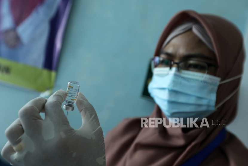 Vaksinasi Daerah Pulau Terpencil Terkendala Cuaca Ekstrem. Seorang petugas kesehatan menyiapkan dosis vaksin selama kampanye vaksinasi COVID-19.